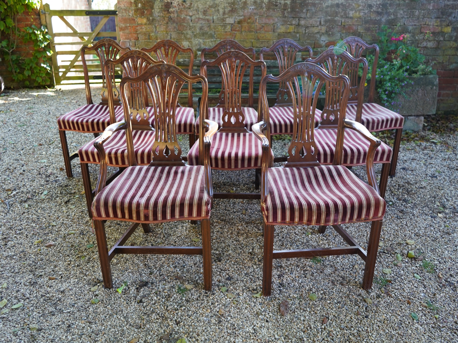 A Fine set of 10 Mahogany Dining Chairs comprising 8 single and 2 matching armchairs. Georgian in style to a design by George Hepplewhite.